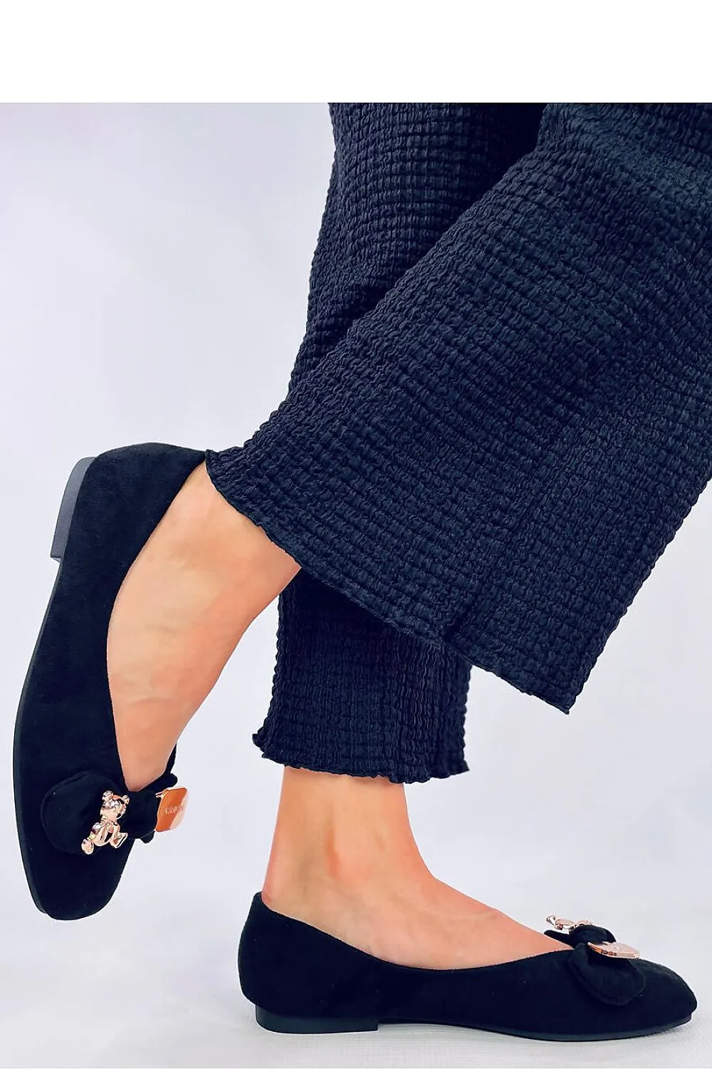 A bow with a gold safety pin and teddy bear Ballet flats