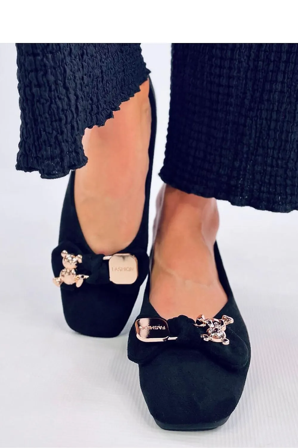 A bow with a gold safety pin and teddy bear Ballet flats